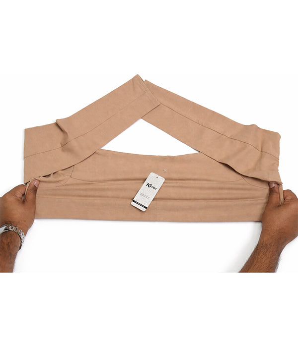 Beige Cotton sleeve extender with a tag held by hands on a white background