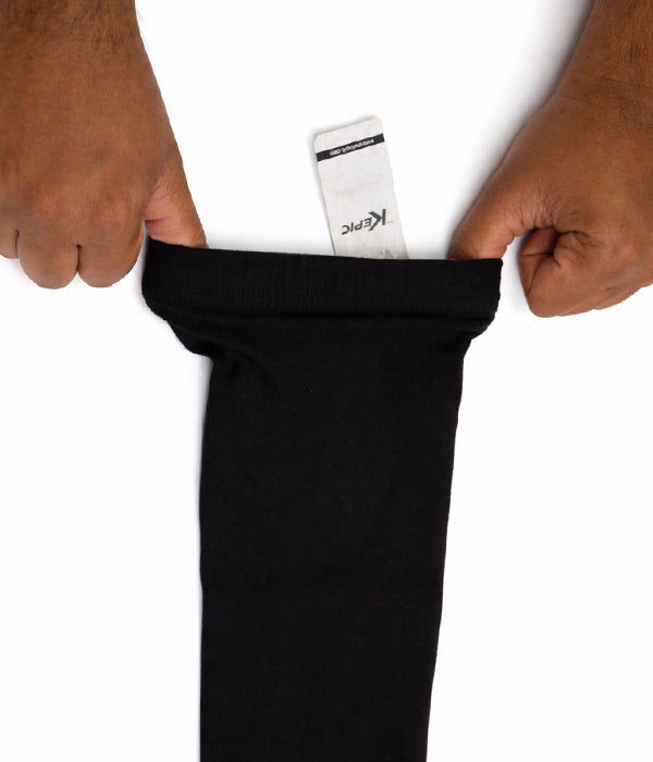 Black sleeve extender with a white card inside, held by hands on a white background