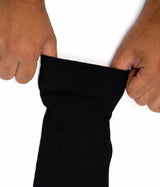 Person stretching a black Mens Sleeve Extenders against a white background